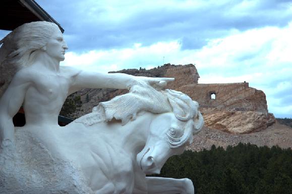 Crazy Horse Memorial: At the rear is the incomplete memorial, at the front is a scale model showing its eventual appearance